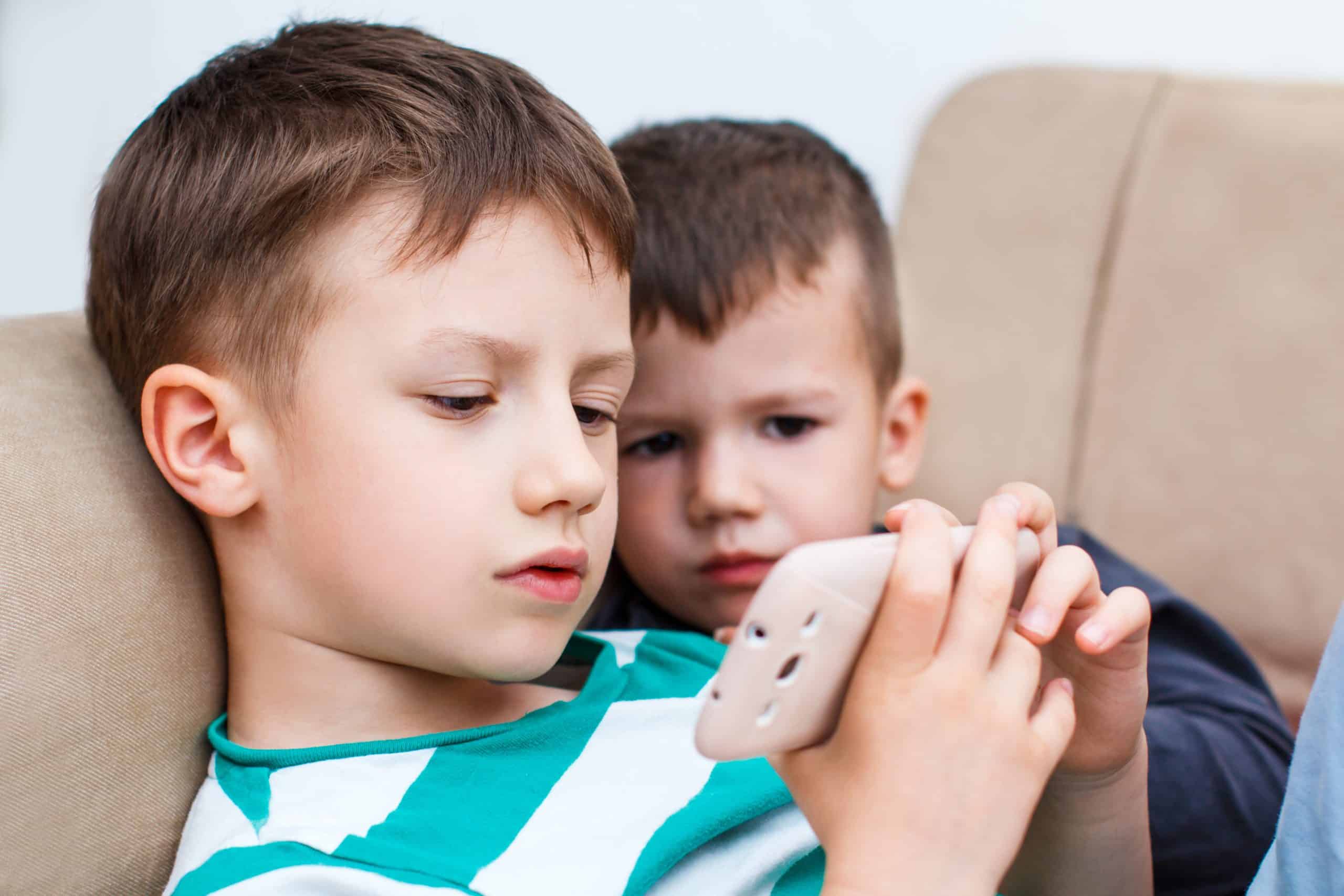 Two boys using a smartphone